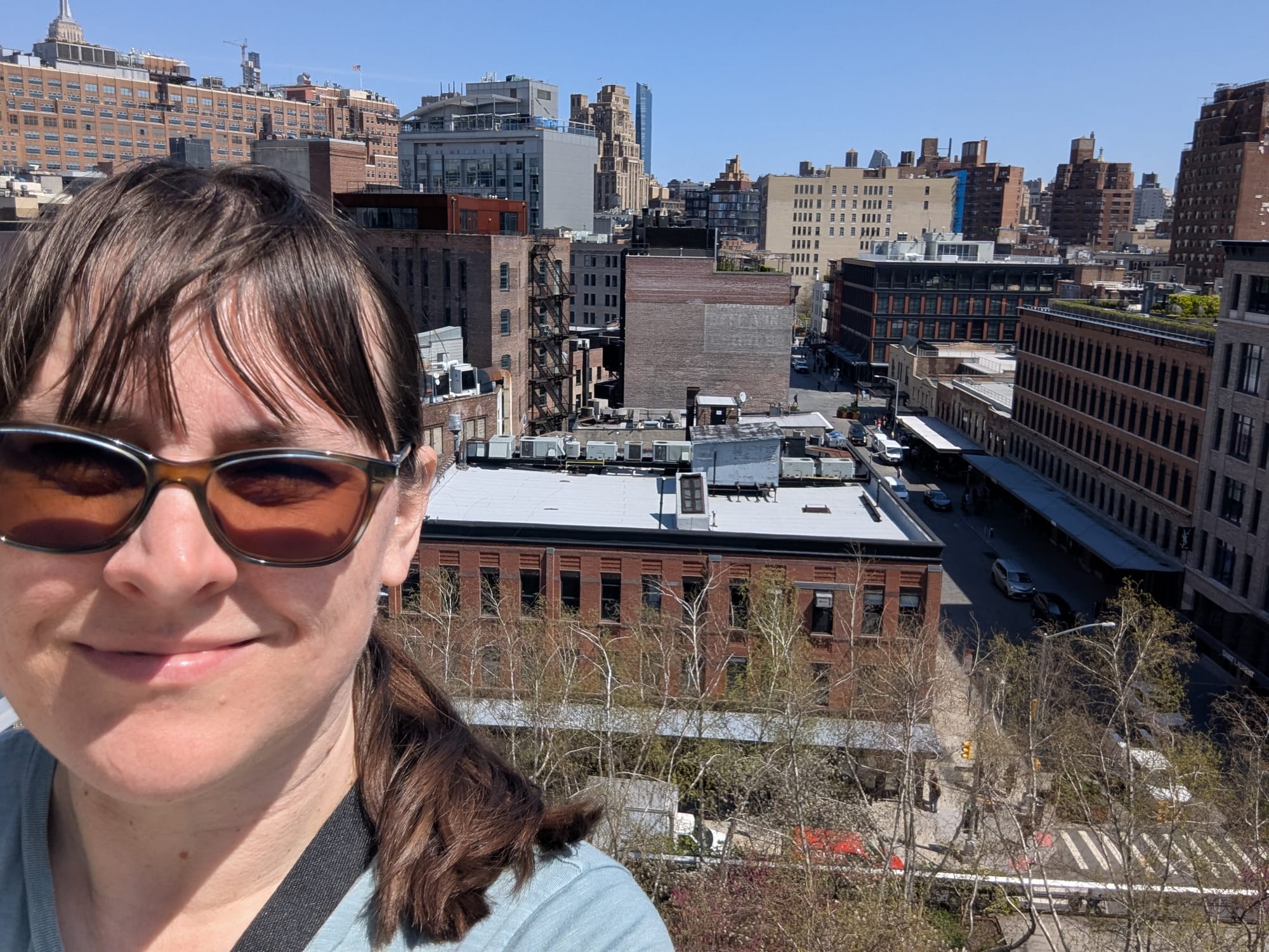 A selfie of me on the balcony of a building in Chelsea, Manhattan, looking onto a cityscape